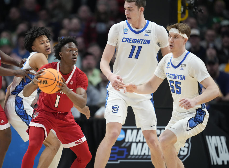 North Carolina State guard Jarkel Joiner, front left, looks to pass the ball as, from left rear, Creighton guard Trey Alexander, center Ryan Kalkbrenner and guard Francisco Farabello defend in the first half of a first-round college basketball game in the men's NCAA Tournament Friday, March 17, 2023, in Denver. (AP Photo/John Leyba)