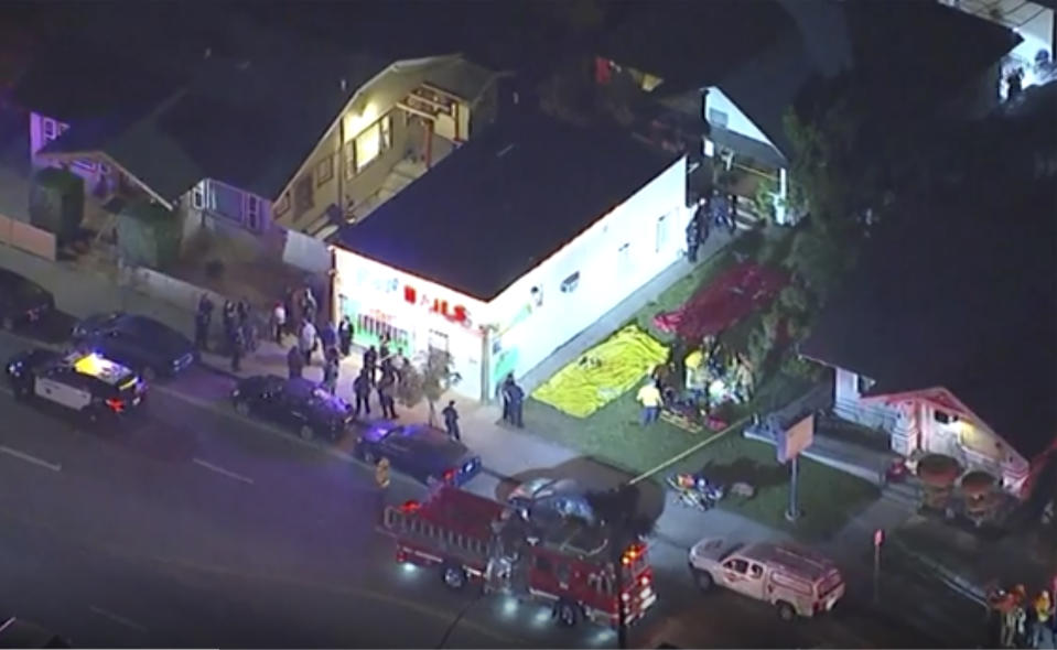 In this aerial image made from video shows the scene where emergency workers have cordoned off an area to deal with victims of a shooting, early Wednesday, Oct. 30, 2019, in Long Beach, Ca. (KABC via AP)