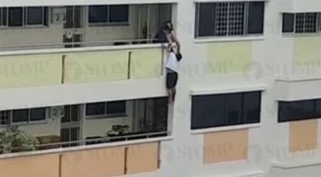 The woman was seen dangling from the balcony. Source: STOMP