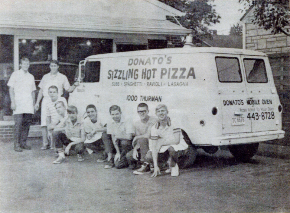 Jim Grote, standing at the far left, poses with an early crew outside the Donatos restaurant at 1000 Thurman Ave. Although a boss he worked for at another pizza place told him to skimp on pepperoni, he decided to arrange his own pizza toppings from edge to edge.