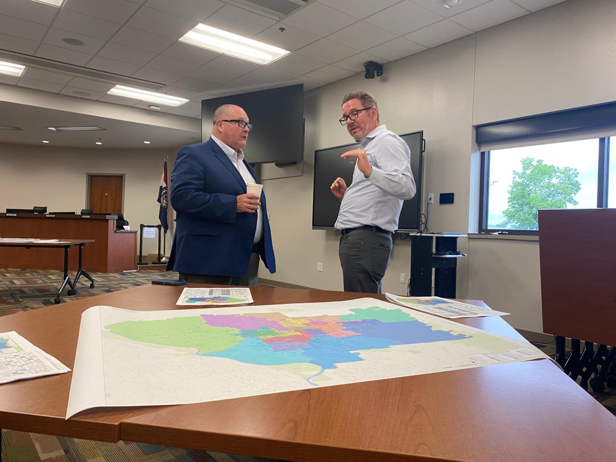 Randy Gooch, Columbia Public Schools chief operations officer, on Tuesday listens to parent Chris Pieper about school boundary options for elementary, middle and high schools.