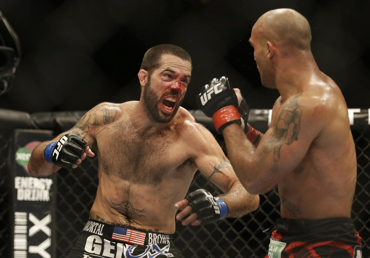 Matt Brown, left, throws a punch at Robbie Lawler during the fifth round of a welterweight mixed martial arts bout at a UFC on Fox event in San Jose, Calif., Saturday, July 26, 2014. Lawler won by unanimous decision. (AP Photo/Jeff Chiu)