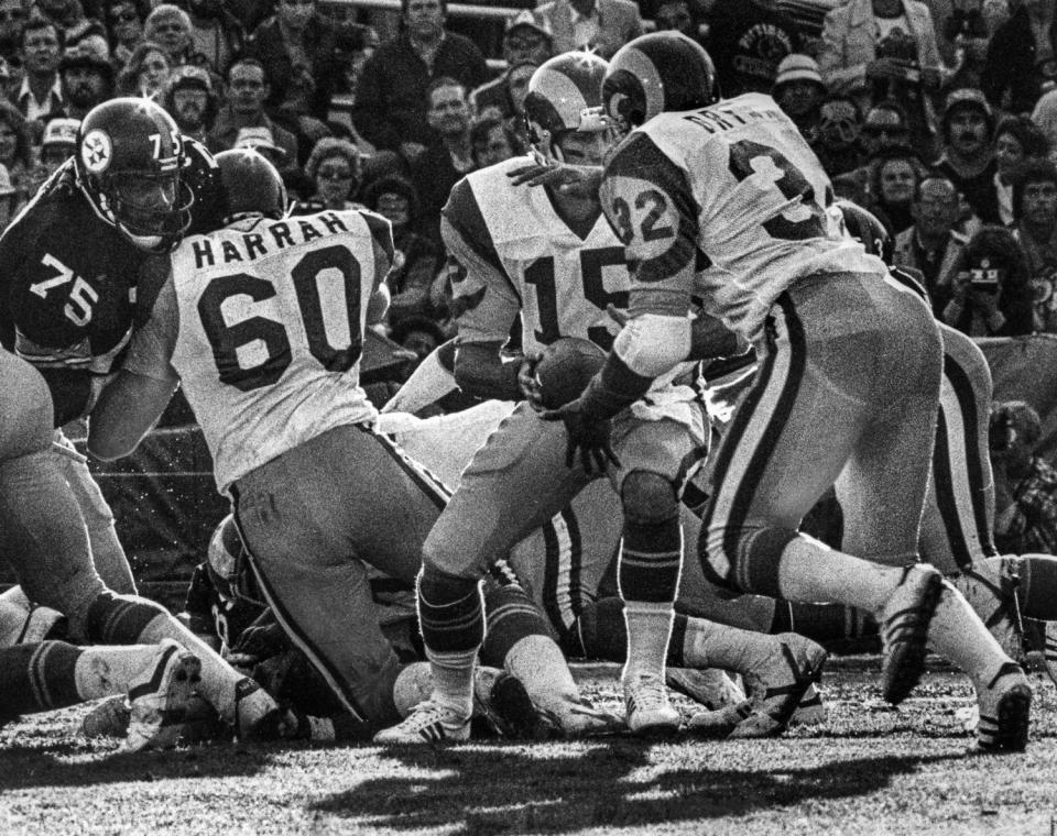 Rams lineman Dennis Harrah (60) blocks Pittsburgh's Joe Greene (75).