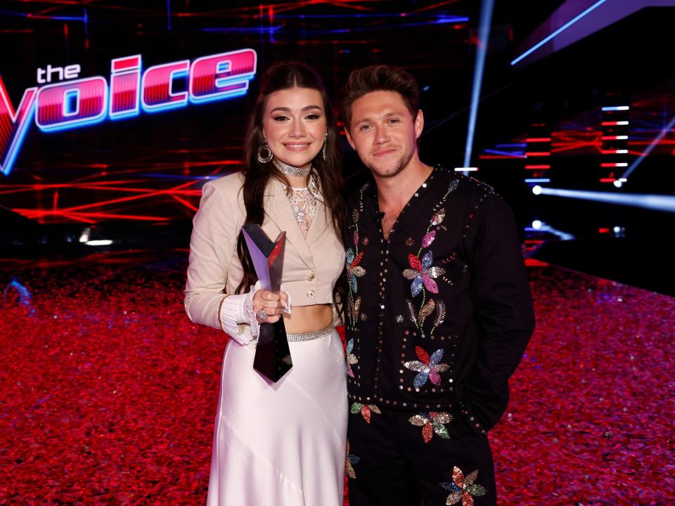 gina miles and niall horan posing together at "the voice" season 23 finale