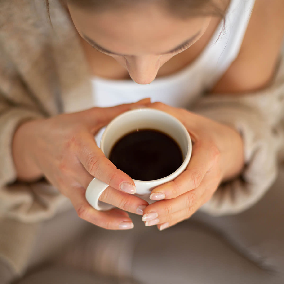 woman drinking black coffee