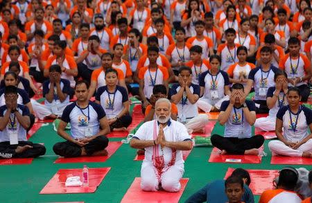 Prime Minister Narendra Modi performs yoga on International Yoga Day in Lucknow, June 21, 2017. REUTERS/Pawan Kumar