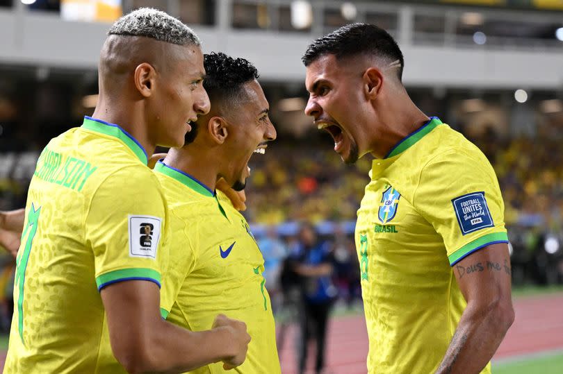 Brazil forward Raphinha celebrates with teammates <a class="link " href="https://sports.yahoo.com/soccer/players/3862676/" data-i13n="sec:content-canvas;subsec:anchor_text;elm:context_link" data-ylk="slk:Richarlison;sec:content-canvas;subsec:anchor_text;elm:context_link;itc:0">Richarlison</a> and midfielder <a class="link " href="https://sports.yahoo.com/soccer/players/1146876/" data-i13n="sec:content-canvas;subsec:anchor_text;elm:context_link" data-ylk="slk:Bruno Guimaraes;sec:content-canvas;subsec:anchor_text;elm:context_link;itc:0">Bruno Guimaraes</a>. -Credit:CARL DE SOUZA/AFP via Getty Images
