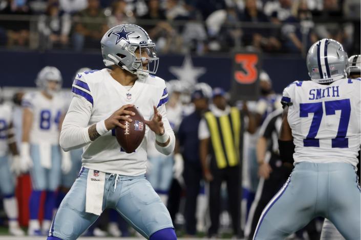 Dallas Cowboys quarterback Dak Prescott (4) drops back to pass as offensive tackle Tyron Smith (77) defends against the rush in the first half of an NFL football game against the Las Vegas Raiders in Arlington, Texas, Thursday, Nov. 25, 2021. (AP Photo/Michael Ainsworth)