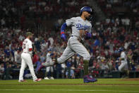 Los Angeles Dodgers' Mookie Betts rounds the bases after hitting a three-run home run off St. Louis Cardinals relief pitcher Chris Stratton, left, during the eighth inning of a baseball game Friday, May 19, 2023, in St. Louis. (AP Photo/Jeff Roberson)