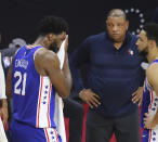 Philadelphia 76ers center Joel Embiid stands near coach Doc Rivers during the final seconds of the team's loss to the Atlanta Hawks in Game 5 of an NBA basketball Eastern Conference semifinal Wednesday, June 16, 2021, in Philadelphia. Embiid had missed two free throws. (Curtis Compton/Atlanta Journal-Constitution via AP)