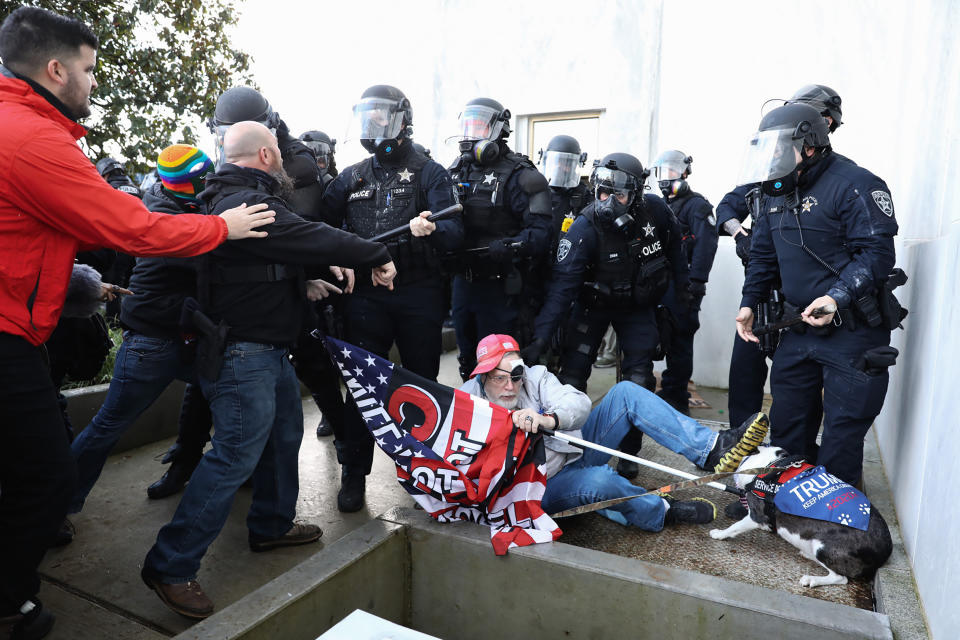 FILE - Law enforcement officers and protesters clash outside the Oregon State Capitol during a special session of the state legislature in Salem, Ore., on Dec. 21, 2020. Over the past decade, Oregon experienced the sixth-highest number of extremist incidents in the nation, despite being 27th in population, according to an Oregon Secretary of State report. Now, the state Legislature is considering a bill that, experts say, would create the nation's most comprehensive law against paramilitary activity. (Brian Hayes/Statesman-Journal via AP, File)