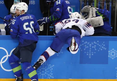 Ice Hockey - Pyeongchang 2018 Winter Olympics - Men's Playoff Match - Slovenia v Norway - Gangneung Hockey Centre, Gangneung, South Korea - February 20, 2018 - Ludvig Hoff of Norway crashes into the boards. REUTERS/Grigory Dukor