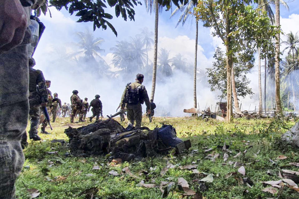 In this photo released by the Joint Task Force - Sulu, personal belongings from victims are retrieved at the site where a Lockheed C-130 Hercules plane crashed in Patikul town, Sulu province, southern Philippines, Sunday July 4, 2021. Philippine troops found the last five dead from the crash of the transport aircraft in the south, raising the death toll to 50 in the military's worst air disaster, officials said Monday. (Joint Task Force-Sulu via AP)