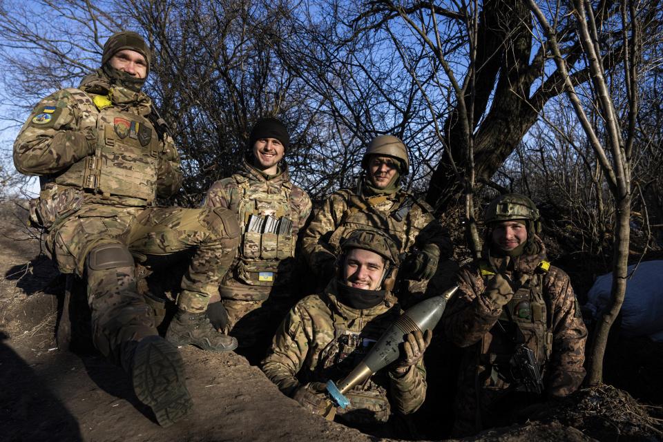 Ukrainian servicemen gather for a group photo at their position on the frontline near Bakhmut, Donetsk region, Ukraine, Wednesday, Jan. 11, 2023. (AP Photo/Evgeniy Maloletka)