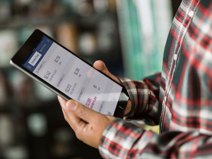 A small business owner using QuickBooks Online on a tablet