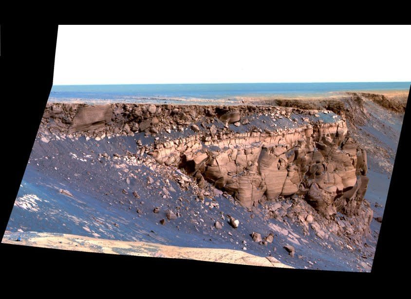 The exploration of Victoria crater by Opportunity revealed some of the most dramatic and picturesque landscapes yet encountered by either rover.  This Pancam sol 1167 (May 7, 2007)  false-color mosaic shows some of the steep, layered cliffs of the promontory called Cape of Good Hope.    <em>From "Postcards from Mars" by Jim Bell; Photo credit: NASA/JPL/Cornell University</em>  