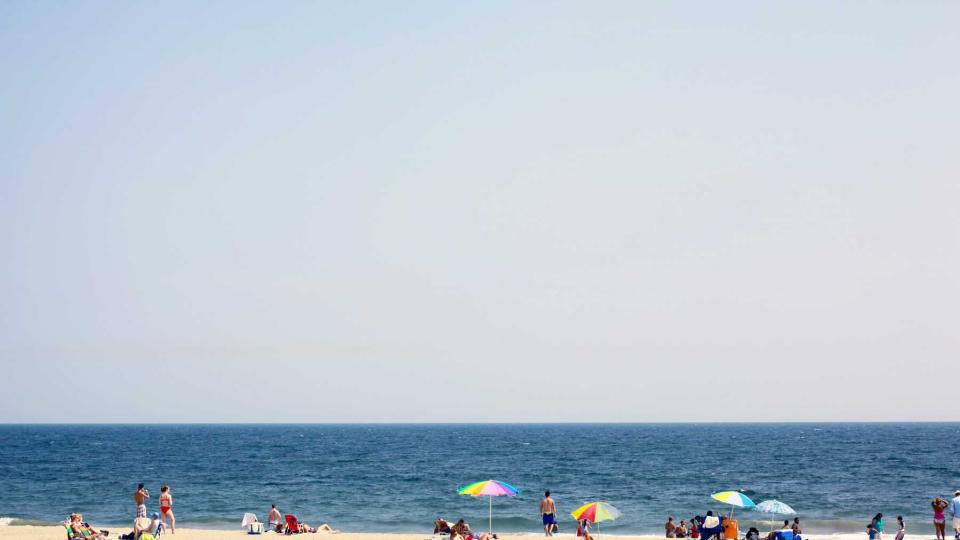 People enjoying Rockaway Beach in Queens, New York