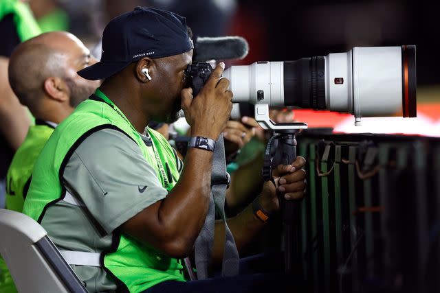 <p>James Gilbert/Getty</p> Hall of Famer Ken Griffey Jr. takes photos in the second half during a match between Nashville SC and Inter Miami CF at DRV PNK Stadium