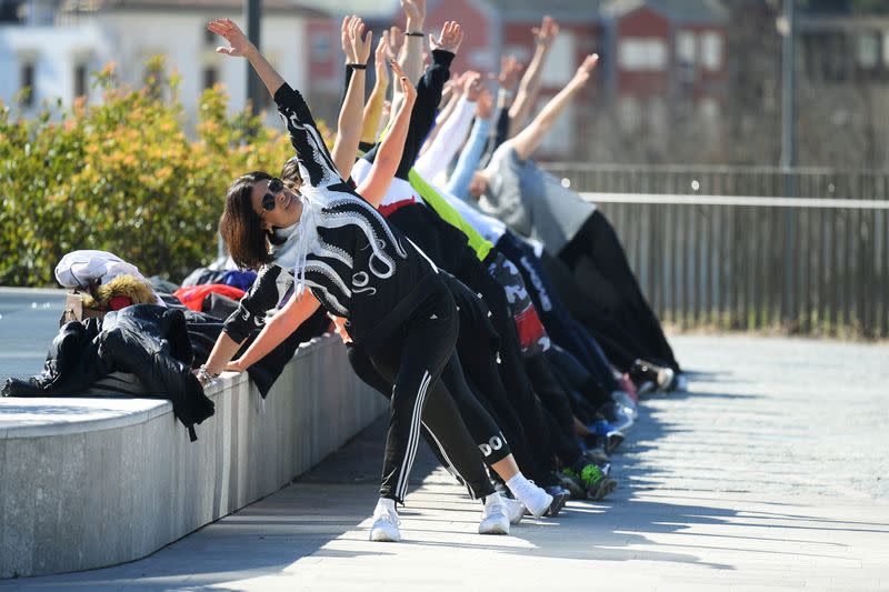 People train in a local park as gyms are closed as part of measures to try and contain a coronavirus outbreak, in Milan