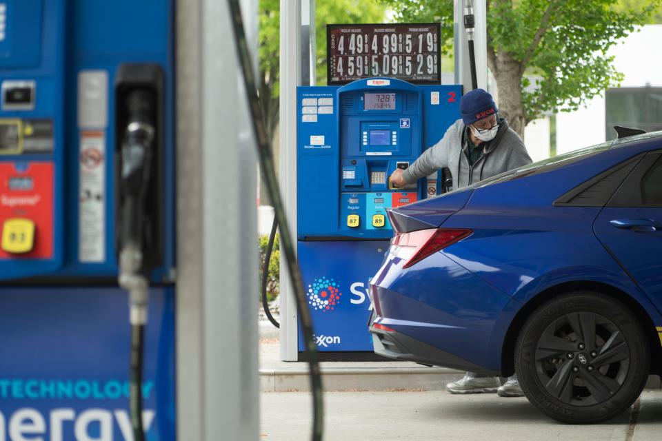 Ahmed Benameur, gas station attendant, pumps gas at the Route 4 Exxon station in Paramus, N.J. on Wednesday May 11, 2022. 