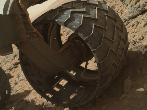 he left-front wheel of NASA's Curiosity Mars rover shows dents and holes in this image taken during the 469th Martian day, or sol, of the rover's work on Mars (Nov. 30, 2013).