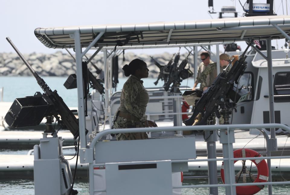 A U.S. Navy personnel prepares at a patrol boat carrying journalists to see damaged oil tankers leaves a U.S. Navy 5th Fleet base, during a trip organized by the Navy for journalists, near Fujairah, United Arab Emirates, Wednesday, June 19, 2019. Cmdr. Sean Kido of the U.S. Navy's 5th Fleet said Wednesday that the limpet mine used on a Japanese-owned oil tanker last week "bears a striking resemblance" to similar Iranian mines. (AP Photo/Kamran Jebreili)