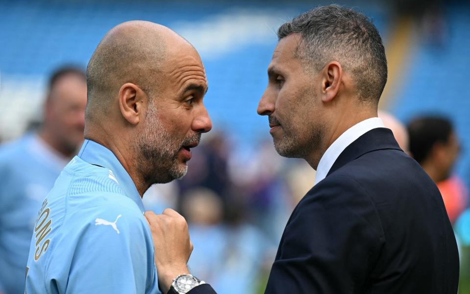 Manchester City's Spanish manager Pep Guardiola talks to Manchester City Emirati chairman Khaldoon al-Mubarak as they celebrate ahead of the presentation ceremony after the English Premier League football match between Manchester City and West Ham United at the Etihad Stadium in Manchester, North West England, on May 19, 2024. Manchester City made English football history on Sunday by beating West Ham 3-1 to win an unprecedented fourth straight Premier League title