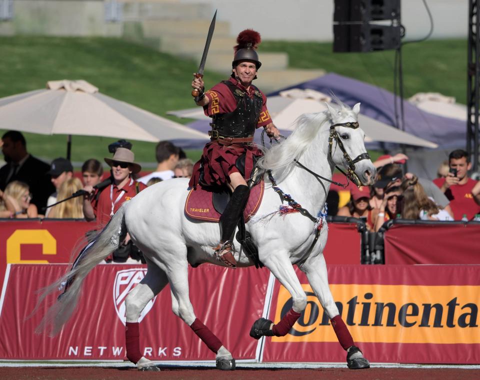 Southern California mascot Traveler with rider Hector Aguilar during the team's game against Colorado at Los Angeles Memorial Coliseum.