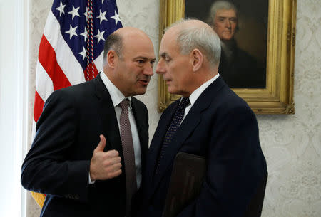 FILE PHOTO: National Economic Council director Gary Cohn (L) and White House Chief of Staff John Kelly speak during a meeting between President Donald Trump and Puerto Rico Governor Ricardo Rossello in the Oval Office of the White House, October 19, 2017. REUTERS/Kevin Lamarque