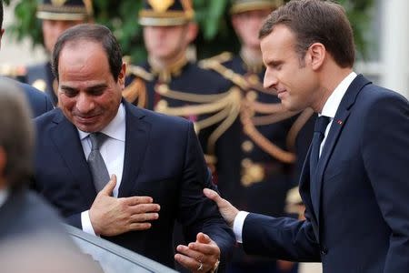 French President Emmanuel Macron greets Egyptian President Abdel Fattah al-Sisi as he leaves the Elysee palace, in Paris, France, October 24, 2017. REUTERS/Philippe Wojazer