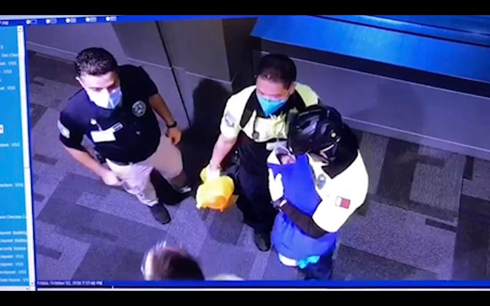 This image made from Oct. 2, 2020 surveillance camera footage obtained by the website Doha News shows officials care for an abandoned baby at Hamad International Airport in Doha, Qatar. Qatar apologized Wednesday, Oct. 28, 2020, after authorities forcibly examined female passengers from a Qatar Airways flight to Sydney to try to identify who might have given birth to the abandoned newborn baby, even as Australia said it was only one of 10 flights subjected to the searches. (Doha News via AP)AP