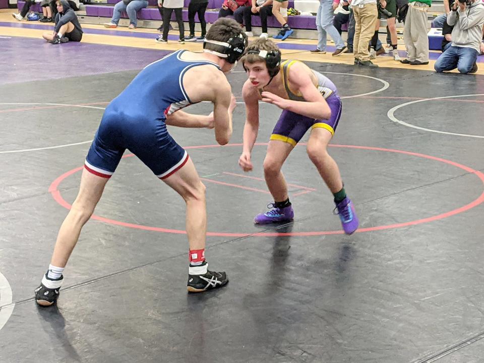 Monty Tech's Zackary Smith-Pratt, right, competes in a match in the 126-pound weight class during Saturday's tournament at Bulldog Gym in Fitchburg.