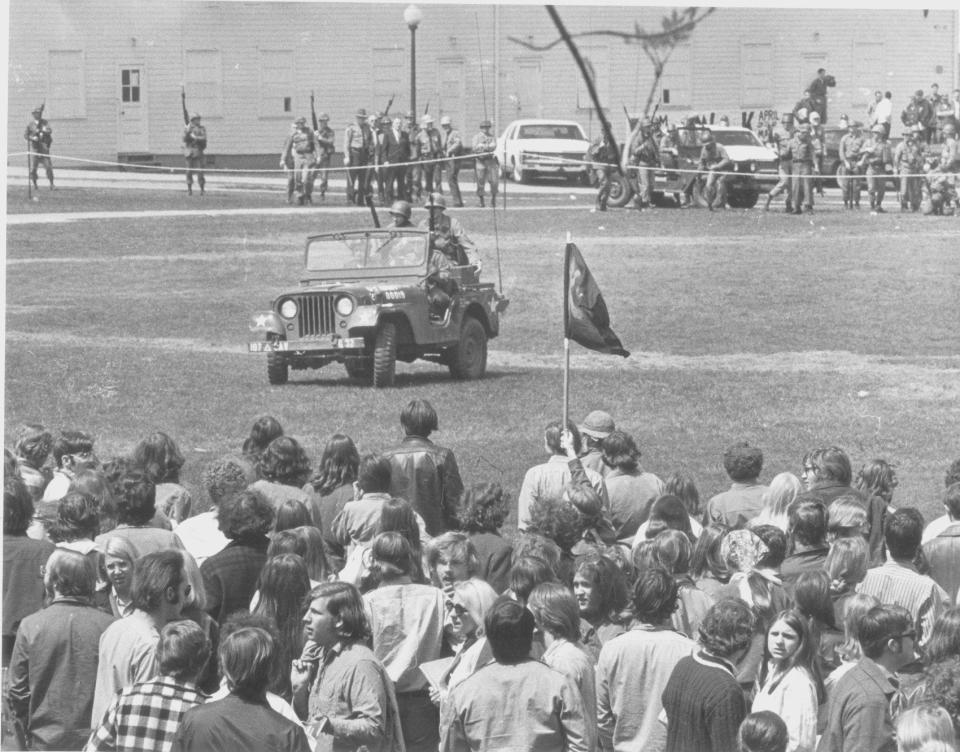 Riding in a jeep, Harold Rice pleads over a bullhorn for Kent State protesters to disperse just before noon on May 4, 1970. (copyright Paul Tople All Rights Reserved)
