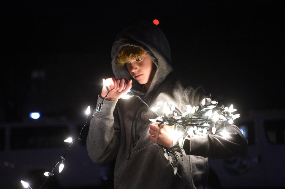 Sequoyah Hills Presbyterian youth assist in decorating a home at Light Up Lonsdale, put on by Thrive, in Lonsdale, Wednesday, Nov. 29, 2023.