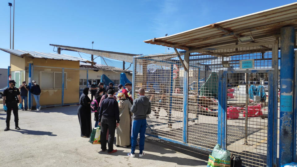 In this Friday, May 22, 2020, photo, Moroccan citizens wait for repatriation after being stranded in Spain due to the coronavirus pandemic in the Spanish enclave of Ceuta, Spain. (Faro de Ceuta via AP)