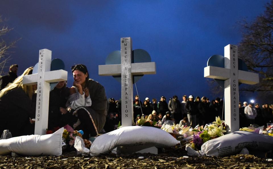 Michigan State University students grieve during a vigil at the Rock on campus on Feb. 15, 2023, where thousands gathered to honor the lives of three students killed during a shooting rampage on campus on Feb. 13.