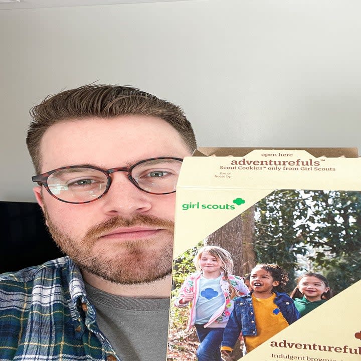 Author holding a box of Adventurefuls up to the camera