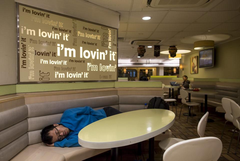A man sleeps at a 24-hour McDonald's restaurant in Hong Kong, China November 11, 2015. A large number of homeless people sleeping on the street has long been been a problem in Hong Kong mainly due to its high rents and soaring property prices. In recent years, the opening of McDonald's 24-hour fast food restaurants all over the city have become popular alternatives for homeless people known as McRefugees or McSleepers to spend the night in a safer and more comfortable way than on the street. McDonaldâ€™s Hong Kong said in a statement that it is accommodating to people staying long in the restaurant for their own respective reasons, while striking a good balance to ensure that customers enjoy their dining experience. REUTERS/Tyrone Siu TPX IMAGES OF THE DAY