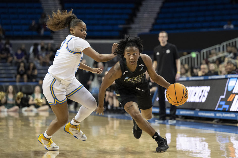 Sacramento State guard Kahlaijah Dean (0) drives toward the basket past UCLA guard Londynn Jones during the first half of a first-round college basketball game in the women's NCAA Tournament, Saturday, March 18, 2023, in Los Angeles. (AP Photo/Kyusung Gong)