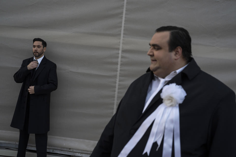 Greek baritone Petros Salatas, right, looks on as Greek baritone Dionisios Sorbs prepares to pose for a photo, backstage of the Odeon of Herodes Atticus for a performance of "Madame Butterfly" in Athens, on Thursday, June 1, 2023. The annual arts festival in Athens and at the ancient theater of Epidaurus in southern Greece is dedicated this year to the late opera great Maria Callas who was born 100 years ago. (AP Photo/Petros Giannakouris)