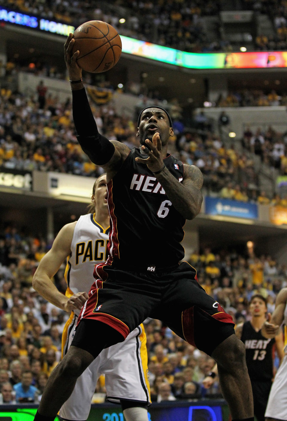 INDIANAPOLIS, IN - MAY 20: LeBron James #6 of the Miami Heat goes up for a shot past Lou Amundson #17 of the Indiana Pacers on his way to a game-high 40 points in Game Four of the Eastern Conference Semifinals in the 2012 NBA Playoffs at Bankers Life Fieldhouse on May 20, 2012 in Indianapolis, Indiana. The Heat defeated the Pacers 101-93. NOTE TO USER: User expressly acknowledges and agrees that, by downloading and/or using this photograph, User is consenting to the terms and conditions of the Getty Images License Agreement. (Photo by Jonathan Daniel/Getty Images)