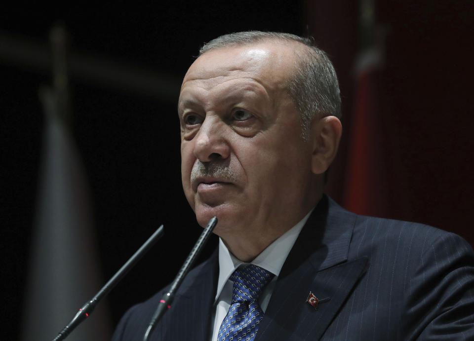 Turkey's President Recep Tayyip Erdogan addresses his ruling party members, in Ankara, Turkey, Friday, July 26, 2019. Erdogan says Turkey is determined to destroy what he called a "terror corridor" in northern Syrian regardless of whether or not Turkey and the United States agree on the establishment of a safe zone. Turkish and U.S. officials have been holding talks for a safe zone east of the river Euphrates to address Turkey's security concerns. (Presidential Press Service via AP, Pool)