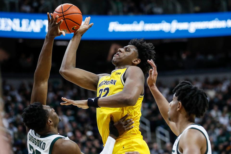 Michigan forward Tarris Reed Jr. (32) shoots the basket against Michigan State center Mady Sissoko (22) during the first half at Breslin Center in East Lansing on Tuesday, Jan. 30, 2024.