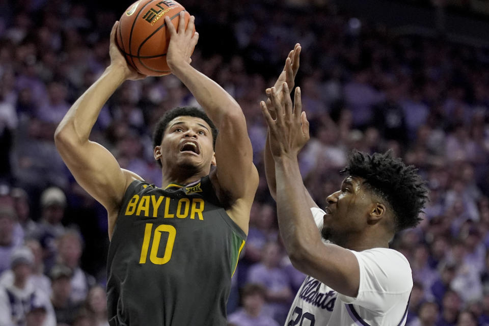 Baylor guard RayJ Dennis (10) shoots under pressure from Kansas State forward Jerrell Colbert during the first half of an NCAA college basketball game Tuesday, Jan. 16, 2024, in Manhattan, Kan. (AP Photo/Charlie Riedel)