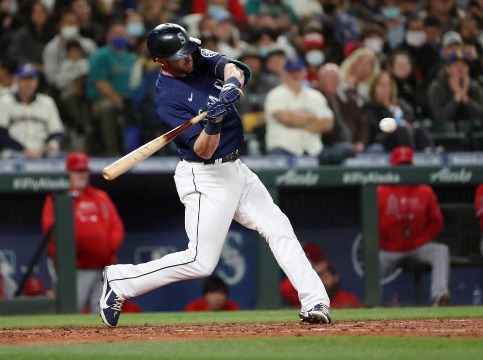 Mitch Haniger of the Seattle Mariners connects for a two-run home run in the fifth inning, breaking a tie with the Los Angeles Angels, at T-Mobile Park on Saturday, Oct. 2, 2021, in Seattle.