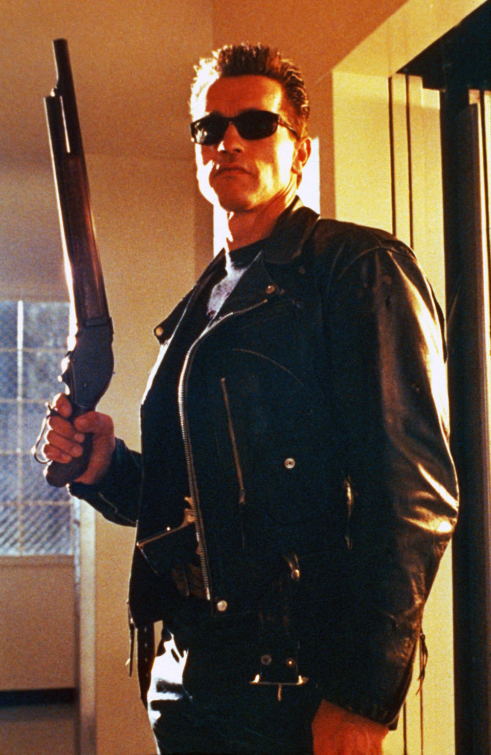 Person in character as The Terminator holding a shotgun, wearing sunglasses and a leather jacket