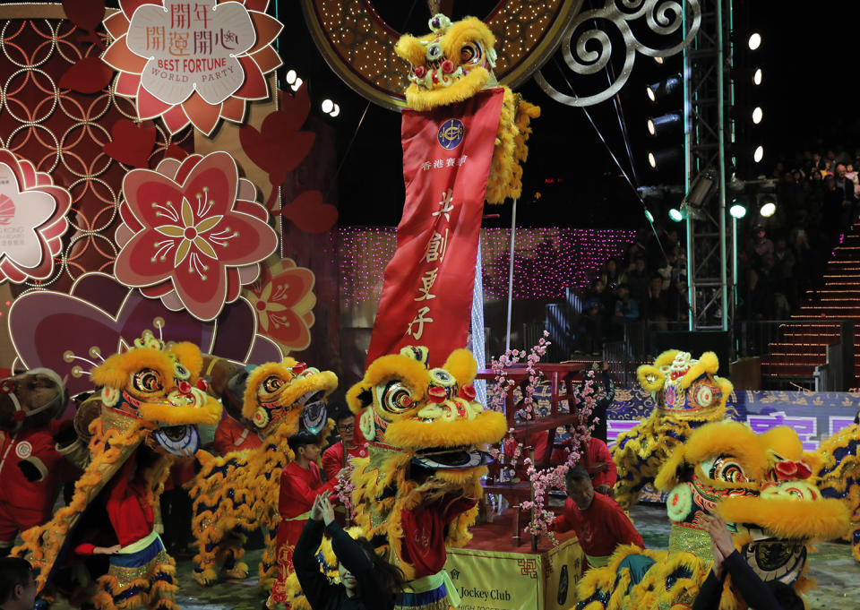 Performers with dragon puppets dance in a night parade to celebrate Chinese New Year in Hong Kong, Saturday, Jan. 28, 2017. The Lunar New Year this year marks the Year of the Rooster in the Chinese calendar. (AP Photo/Vincent Yu)