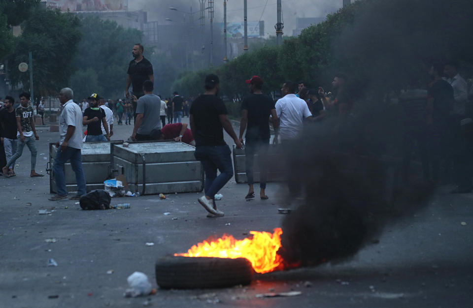 Protesters burn tires and block a street during a demonstration in Baghdad, Iraq, Tuesday, Oct. 1, 2019. Iraqi security forces fired rubber bullets and tear gas in Baghdad Tuesday on protesters demonstrating against corruption and poor public services injuring more than a dozen people, medical official said. (AP Photo/Hadi Mizban)