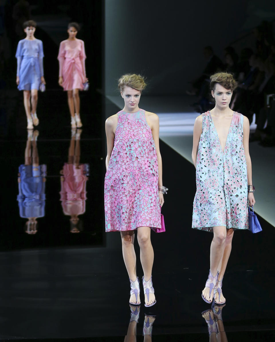 Models wear creations for Giorgio Armani's women's Spring-Summer 2014 collection, part of the Milan Fashion Week, unveiled in Milan, Italy, Monday, Sept. 23, 2013. (AP Photo/Antonio Calanni)