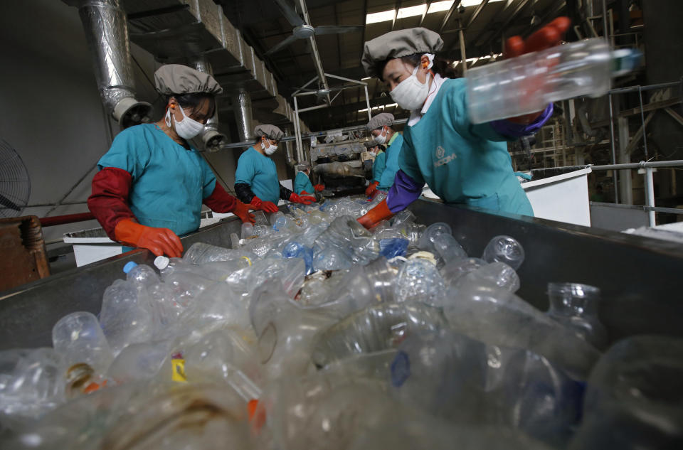 Workers sort through plastic bottles at a recycling facility in Beijing.&nbsp;&nbsp; (Photo: Kim Kyung Hoon/Reuters)